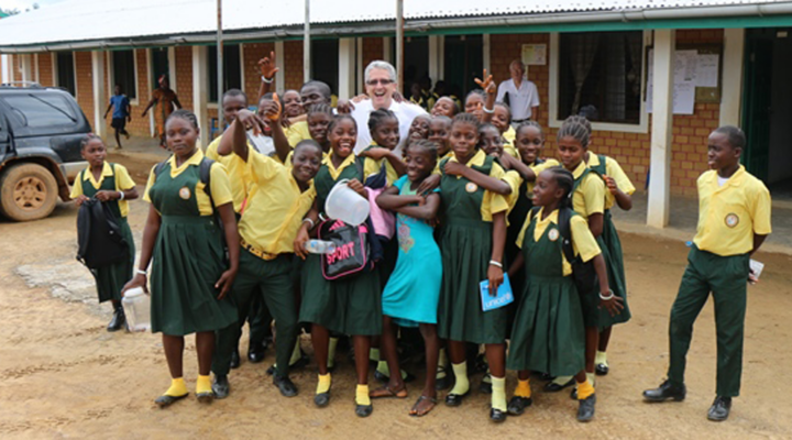 Eric Kellerer poses with a group of Liberian grade school students