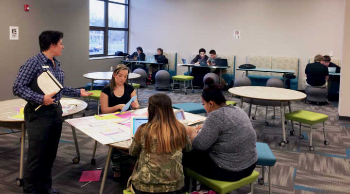 Students sit at a table at STEM Academy