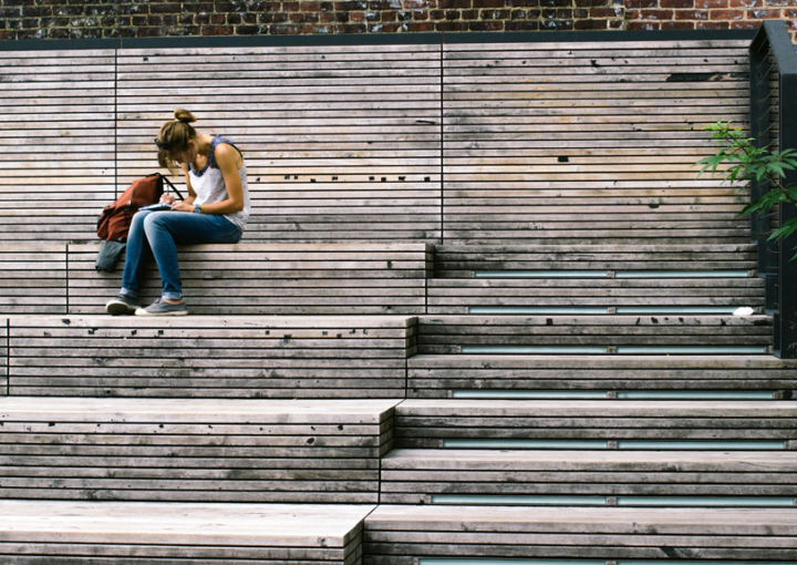 A student sits on steps studying outside