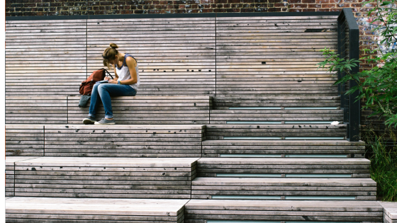 A student sits on steps studying outside