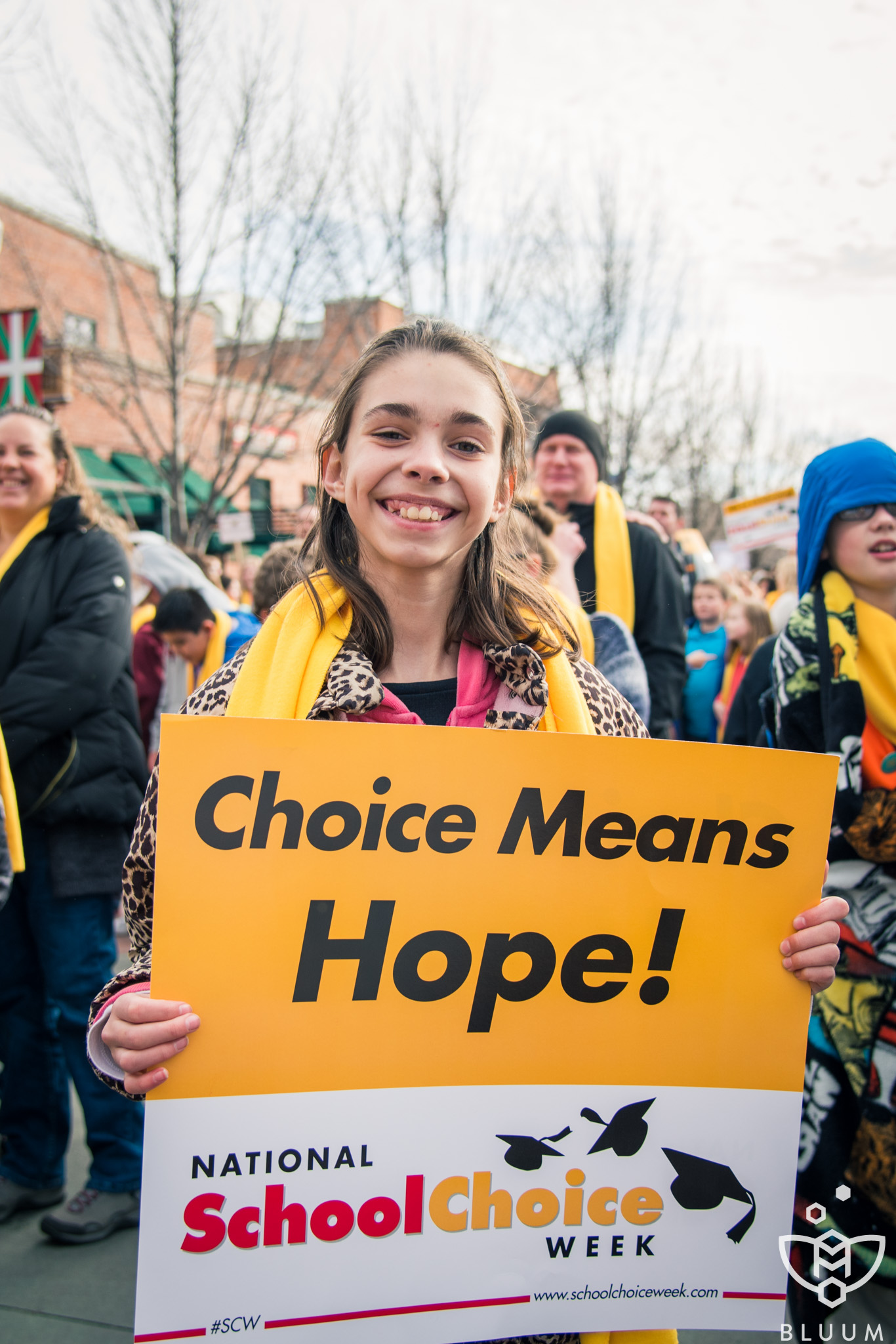 A student holds up a sign that says "Choice Means Hope" for National School Choice Week