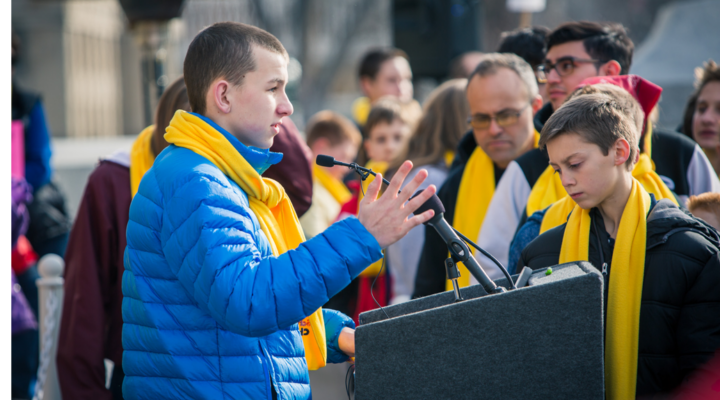 A student stands at the podium at the Boise Capital to discuss National School Choice Week