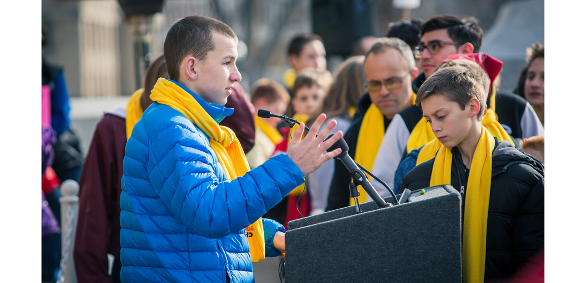 A student stands at the podium at the Boise Capital to discuss National School Choice Week