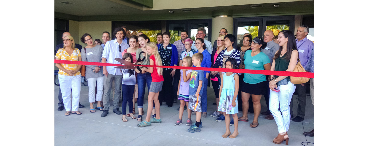 Sage students and families cut the ribbon on Sages new unified building