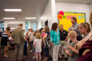 The crowd of well wishers at the Idaho Arts Ribbon Cutting Ceremony stand together in the building