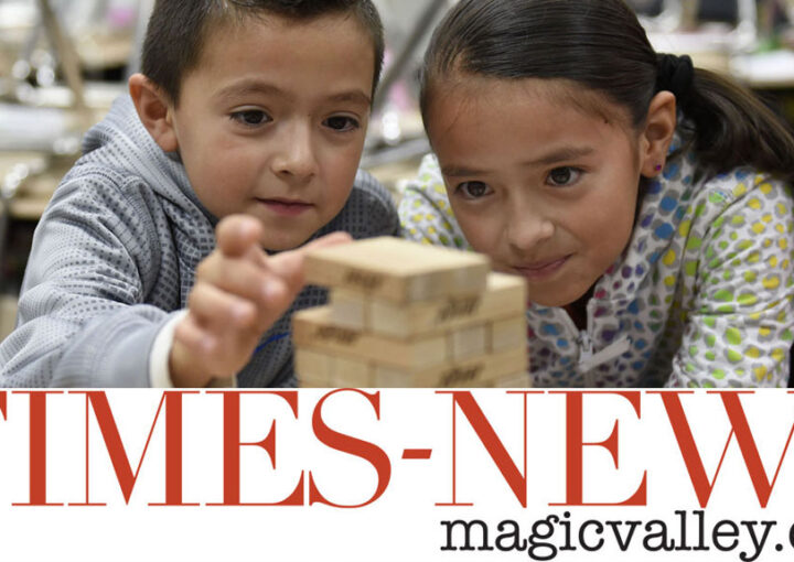 Two children play Jenga