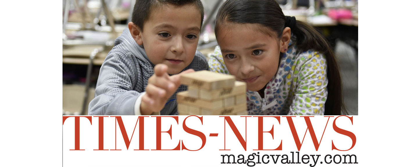 Two children play Jenga