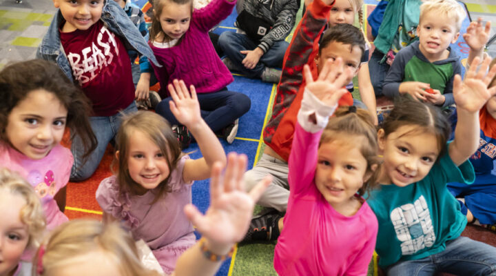 Children in a kindergarten class smile at the camera at Gem Prep in Nampa