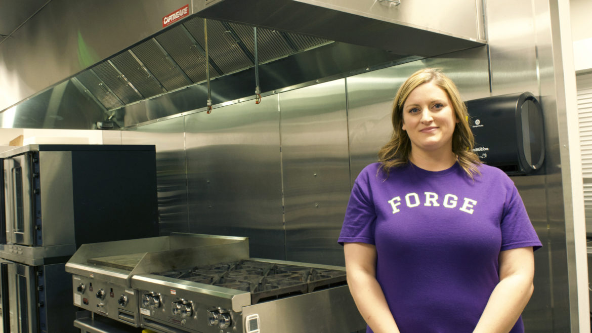 Monica Harshman stands in front of the stove in the Forge Kitchen