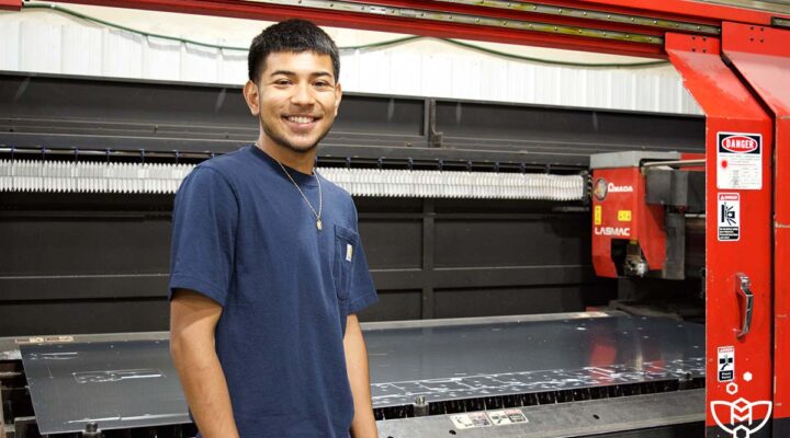 Senior Mario Mario Cabrera-Navarro stands by a machine at Steelhead Metal Corp