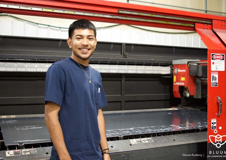 Senior Mario Mario Cabrera-Navarro stands by a machine at Steelhead Metal Corp