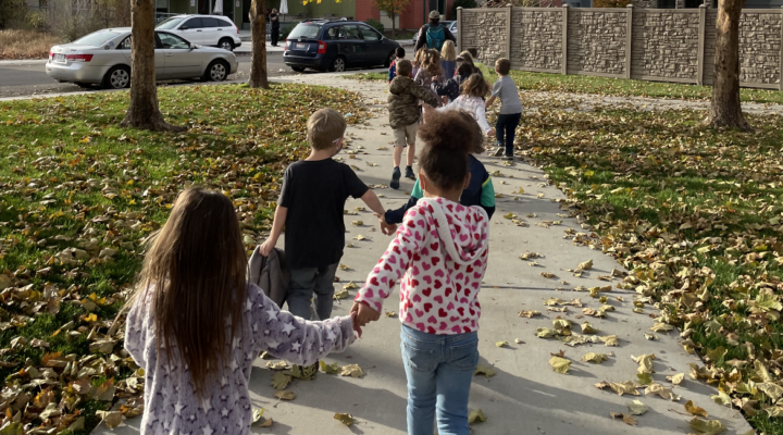 Anser students buddy up to stroll through a nearby park. Photo courtesy of Anser Charter School.