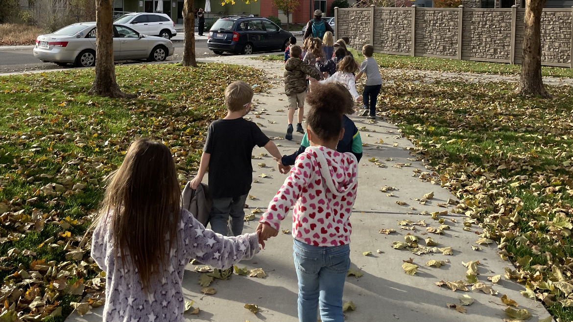 Anser students buddy up to stroll through a nearby park. Photo courtesy of Anser Charter School.