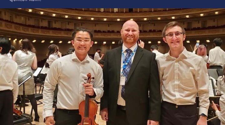 IACS students stand on stage at Carnegie Hall with their instructor