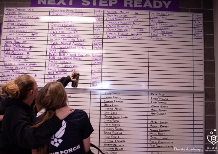 A student and her mom point at the '80 for 80' board