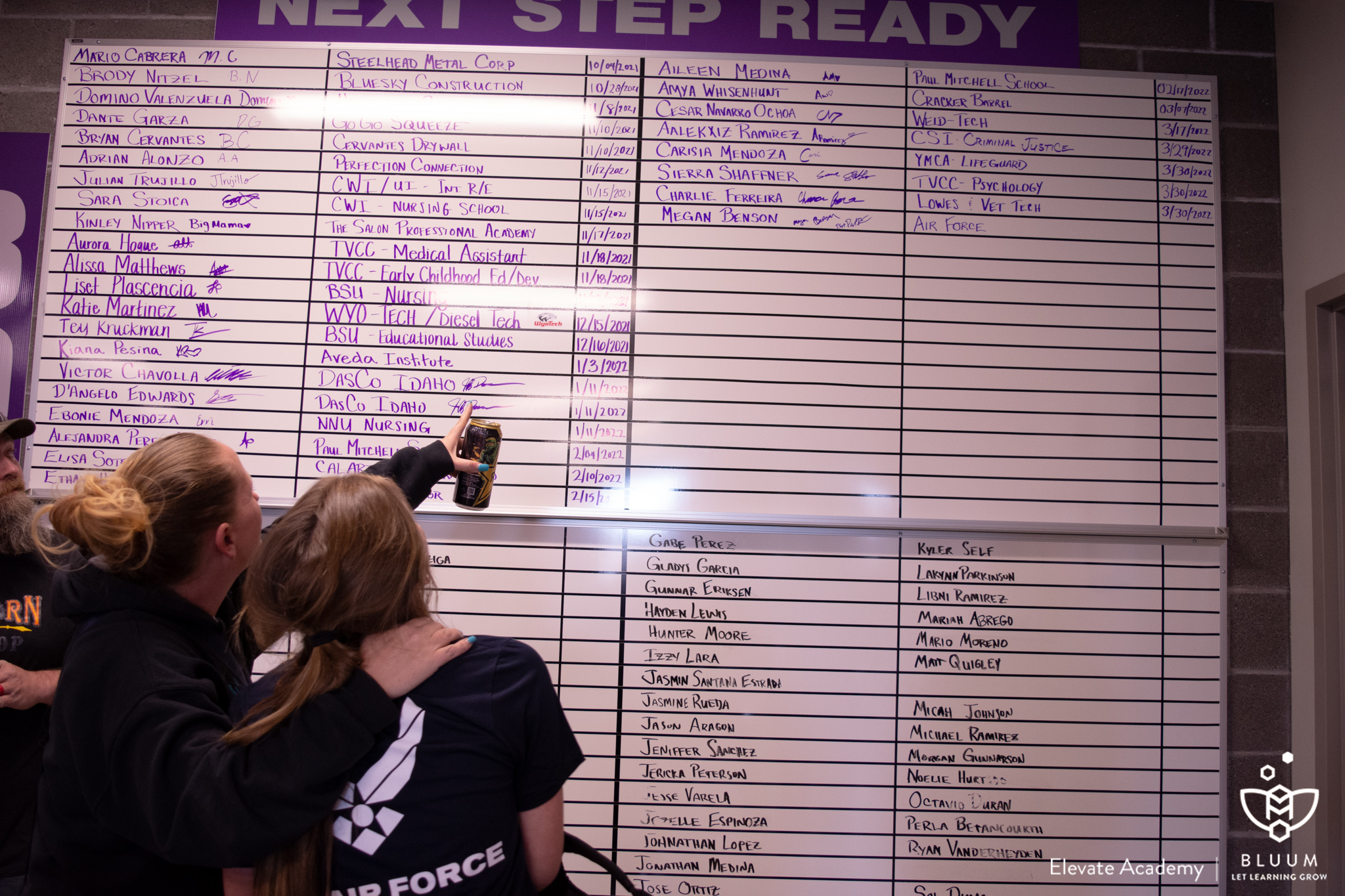 A student and her mom point at the '80 for 80' board